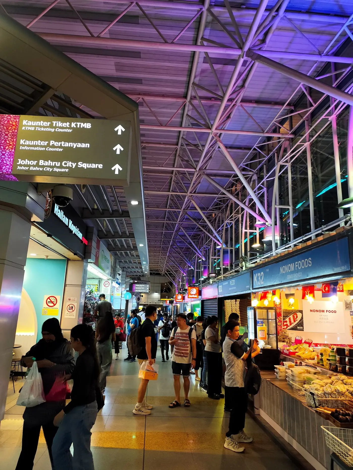 Shops and travellers inside JB Sentral station